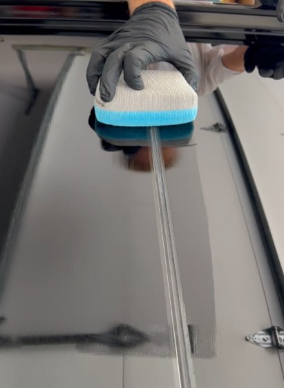 Ceramic coating being applied to a panel with an applicator block