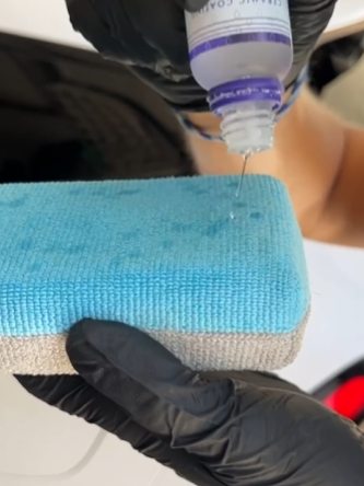 Ceramic coating being dispensed onto an applicator pad
