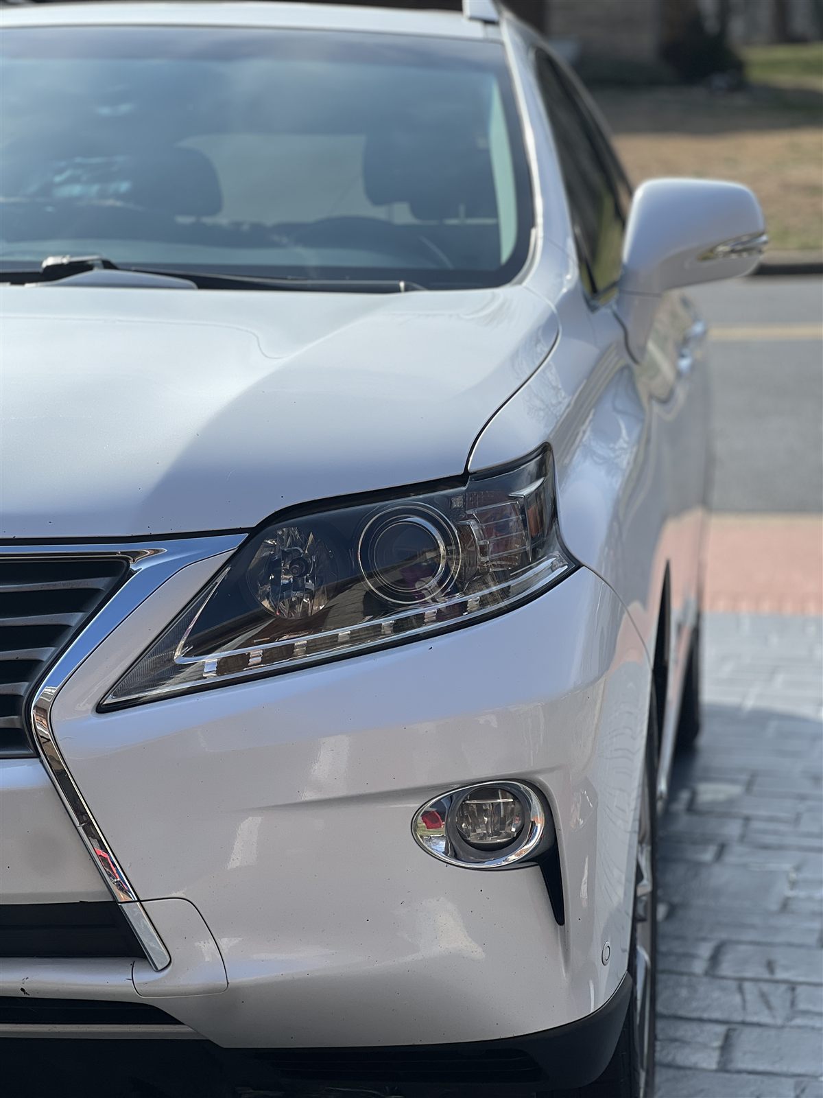 Restored headlight on a white Lexus, lens polished clear